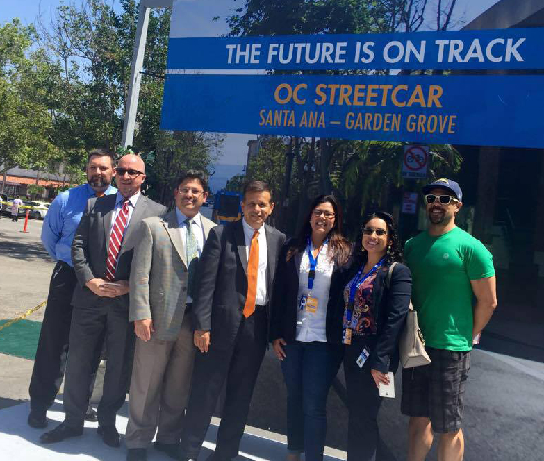 Michele Martinez, third from right, at the announcement for Orange County's planned street car. Martinez has been one of the biggest advocates of active transportation in Santa Ana. Photo Courtesy of Michele Martinez. From left, Jason Gabriel, Santa Ana Public Works Agency; Fred Mousavipour, Executive Director of Santa Ana Public Works Agency; William Galvez, Public Works Agency; Santa Ana Mayor Miguel Pulido; Michele Martinez, Santa Ana Ward 2 council member; Alma Flores, Santa Ana public information officer; Sean Coolidge, Historic Resource Commissioner.