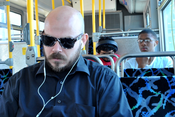Cody Miller (foreground) relies on the GET bus as his only form of transportation to get to and from work, and often finds it constraining. “I could work more hours if the buses ran later,” says Miller. Kevin Martin (right) says he “only rides the bus a couple times a month” when he “needs to go somewhere.”