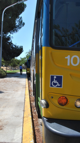 The buses wait as Vinson makes a phone call during a scheduled break at Cal State University Bakersfield. The CSUB and Bakersfield College lines were two of the routes overhauled in 2012 to accommodate a projected influx of riders as the city grows.