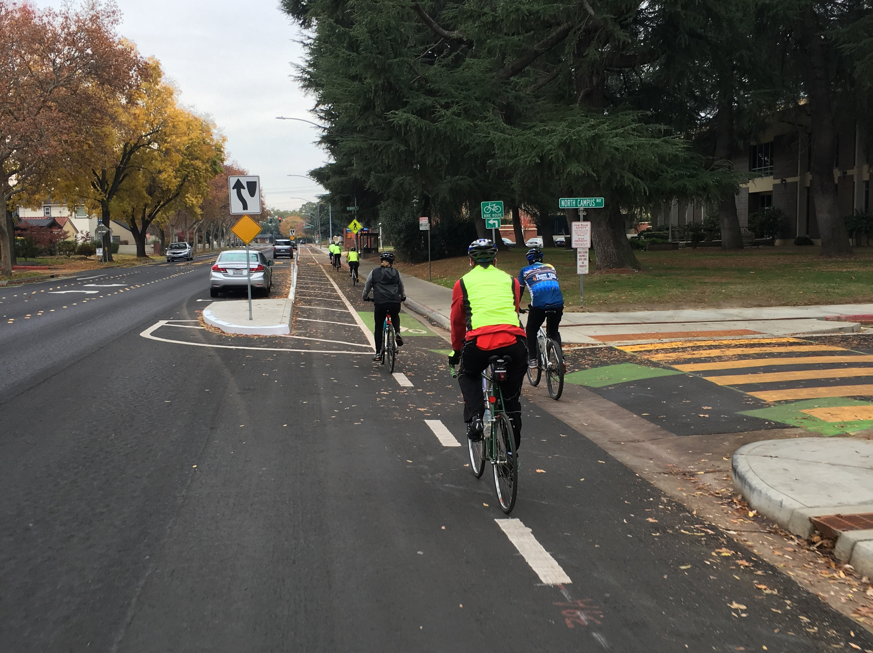 Riders enter the new parking-protected bike lane along XX Ave. Photo: Michael Sacuskie