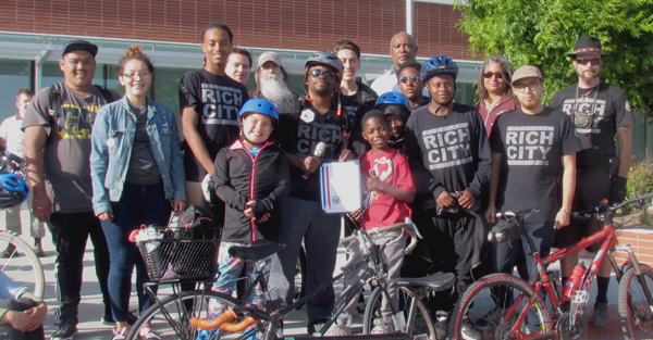 Najari Smith, center, and the Rich City RIDES crew pose with their Mayoral Certificate of Appreciation. Photo: Melanie Curry/Streetsblog