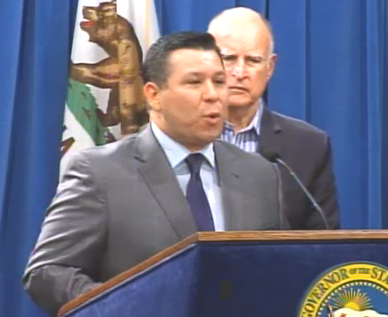 Assemblymember Eduardo Garcia (D-Coachella Valley), flanked by Governor Jerry Brown, addresses the press after two major climate change policy bills passed.