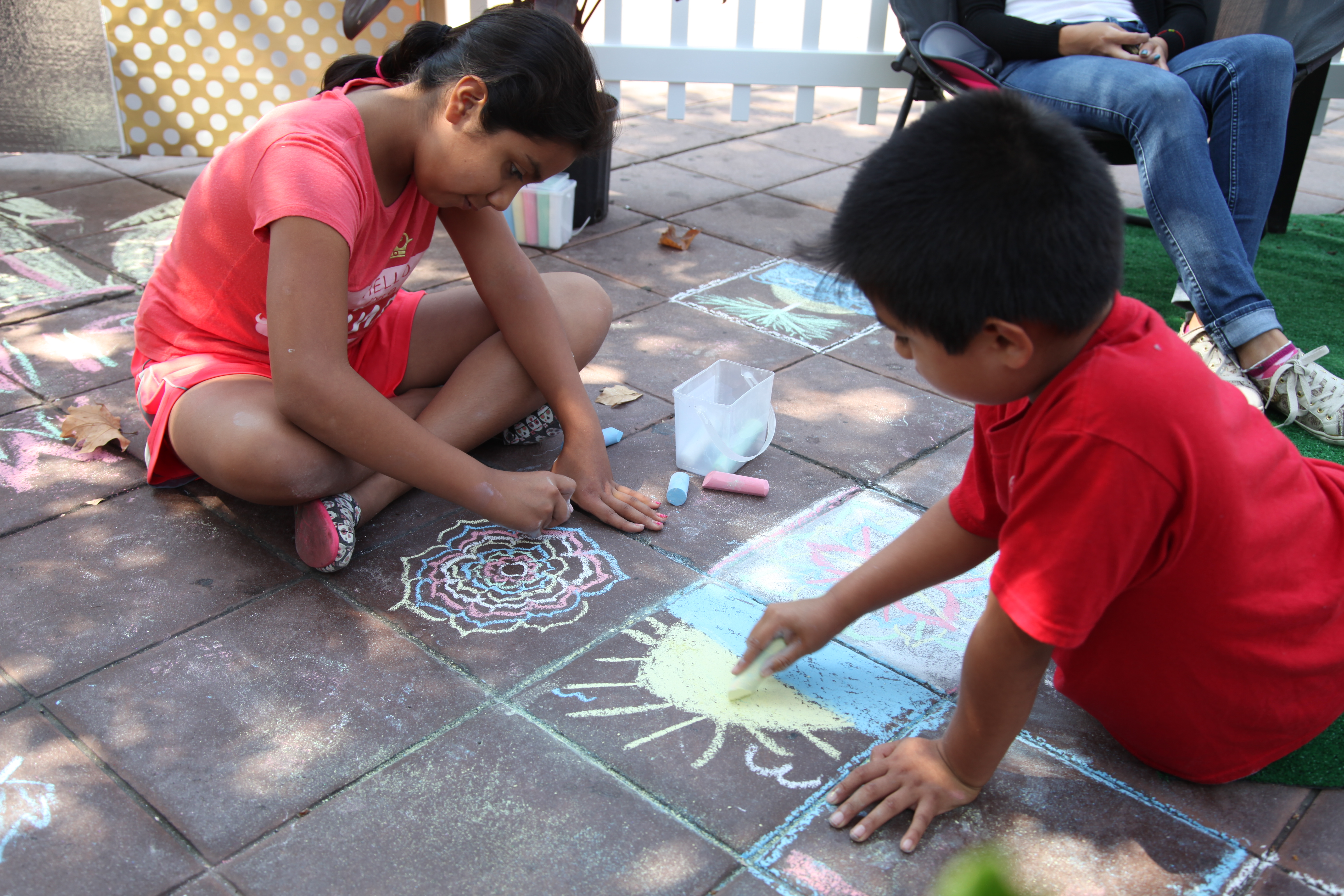 Sonia, 11, Brian 8, draw on the floor at Santa Ana resident's parklet in downtown Garden Grove. Photo by Kris Fortin