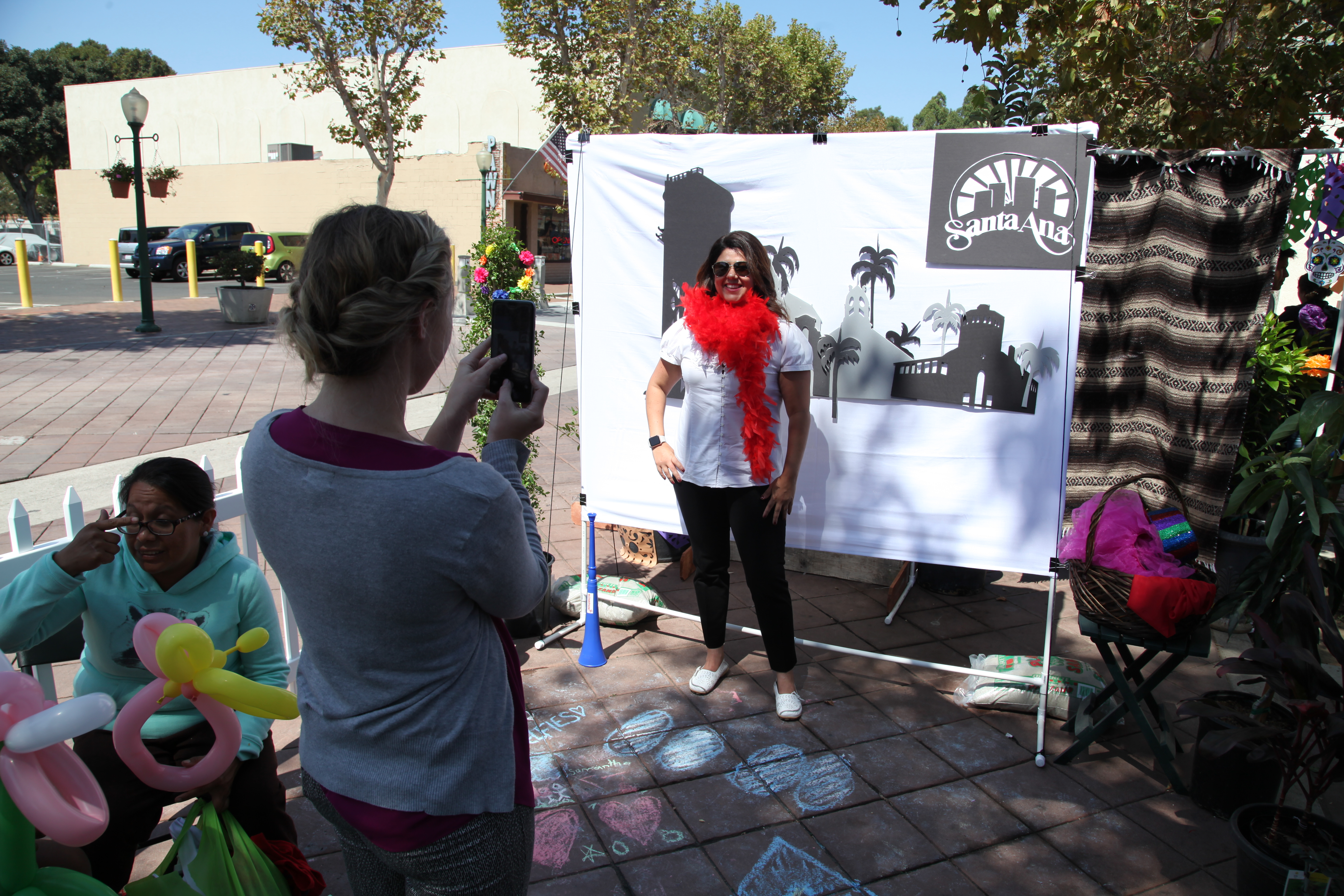Michele Martinez, right, posing at the Santa Ana photo booth during Saturday's (Park)ing Day event. Photo by Kristopher Fortin
