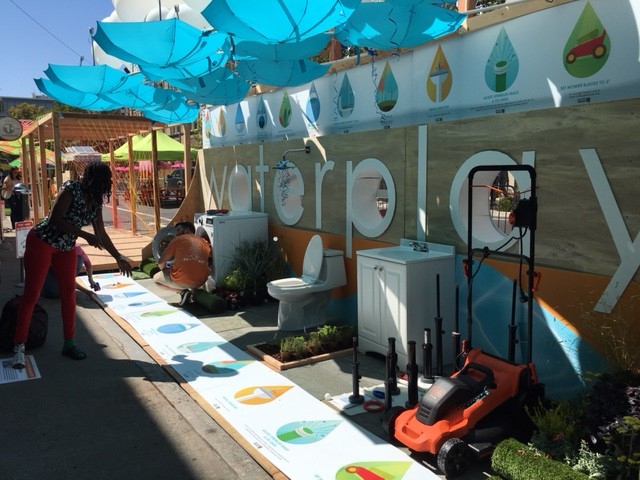 This booth in Sacramento combined water education with games, including one that required a very high level of skill and patience: throwing ping pong balls into a toilet. Photo: Melanie Curry/Streetsblog