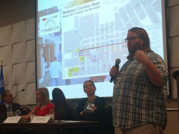 Cory Wilkerson, Santa Ana's active transportation coordinator, speaks to the crowd at May's OC PICH forum. City led and community led plans, like the Wellness Corridor project from Latino Health Access, helped the City identify projects to design and install once OC PICH funds were made available.