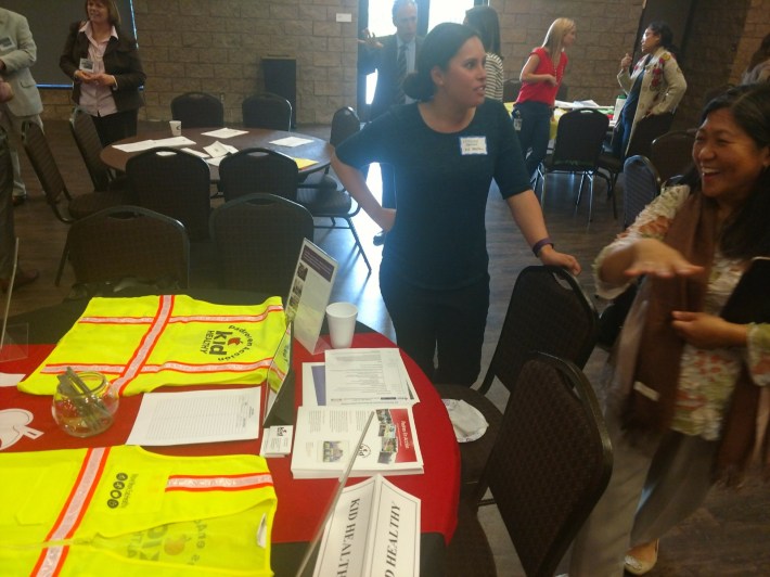 Kid Healthy Staff talking to an attendee. After the forum, attendees were encouraged to meet staff from the OC PICH partners.