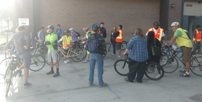 Bike to Work Day group meeting behind the Caltrans offices in Santa Ana. When bicyclists were meeting in the building's front entrance, cyclists were told that a large group couldn't meet there and were redirected to the loading dock. Photo by Kristopher Fortin.