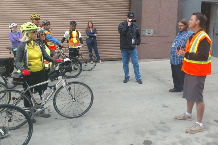 Ryan Chamberlin, Caltrans District 12 director, in safety vest, welcomes bicyclists prior to the start of the ride.