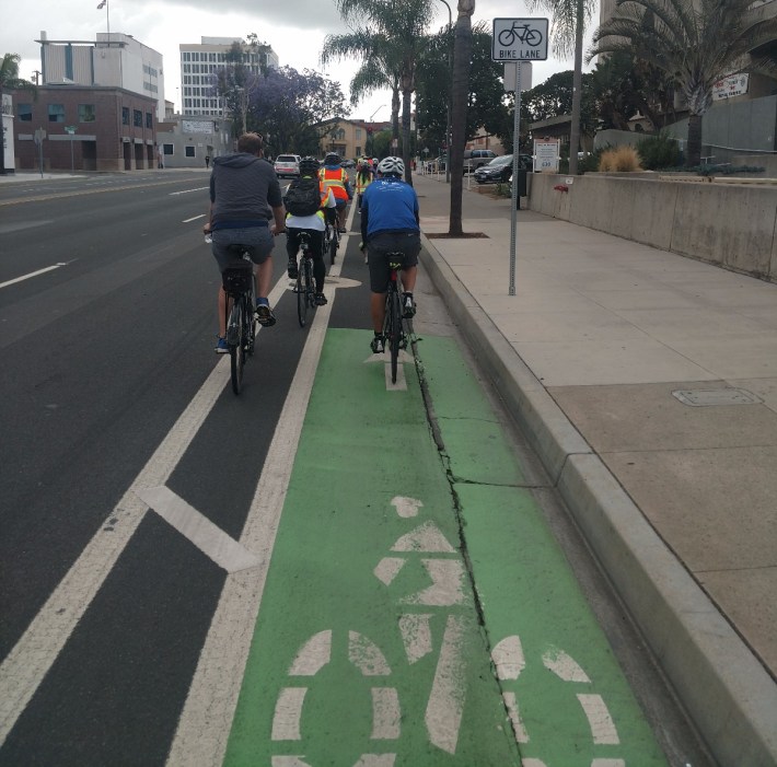 Green-striped bike lanes on Civic Center Drive headed East.