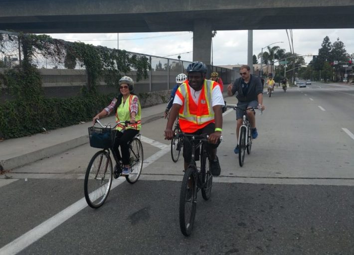 Marlon Regisford, associate transportation planner and district 12’s bicycle and pedestrian coordinator (front right), crosses Fourth Street heading east toward Caltrans District 12 offices.