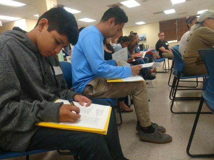 Josue Cruz, 12 (from let), and Luis Ruvalcaba, 15, participate in an exercise to practice how to make public comment at government meetings. Kristopher Fortin/Streetsblog CA