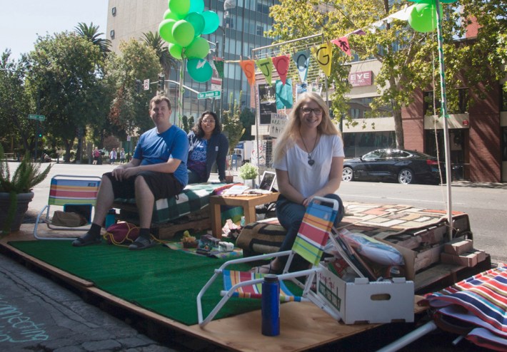 Dustin Brakebill, left, host of the local radio program The Voice of Stockton, is joined by Christine Corrales and Summer Anderson of the San Joaquin Council of Governments at a the PARK(ing) Day parklet. Photo: Minerva Perez/Streetsblog