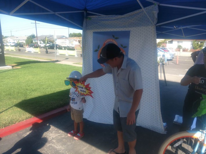 Community members pose for a photo at the Redefine Hazard photobooth. Kristopher Fortin/Streetsblog CA