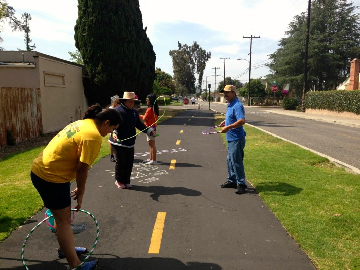 Santa Ana residents hula hoop and jump rope on the Pacific Electric Bike Trail. In 2012, Santa Ana residents that participated in the NeighborWorks Community Leadership Institute hosted a mini-open streets event at the Pacific Electric Bike Trail. Image: Santa Ana Active Streets