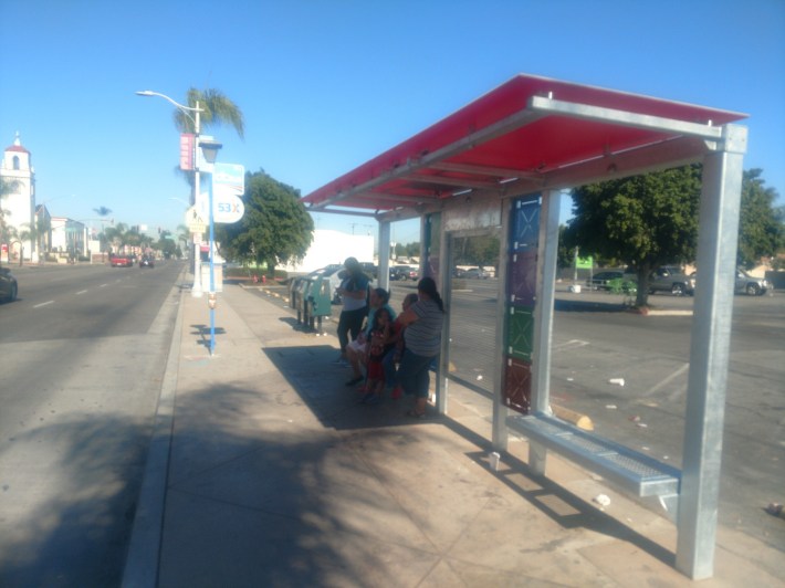 Riders wait for a bus at South Main Street near Edinger Avenue. Kristopher Fortin/Streetsblog CA