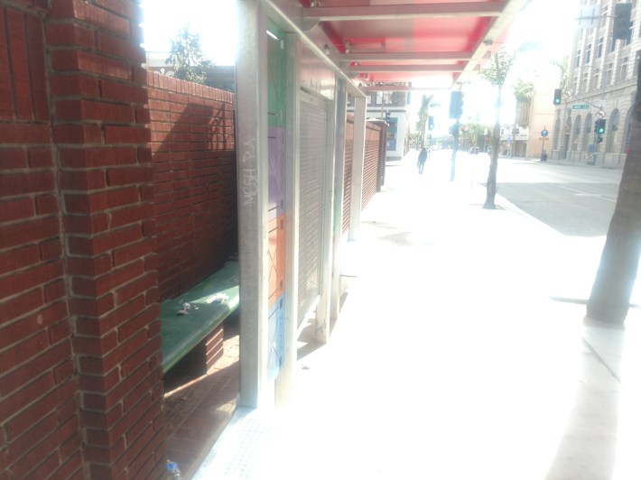 Bus Shelter on Main Street, adjacent to Fourth Street. The bus shelter was installed in front of already existing benching built into the wall of the