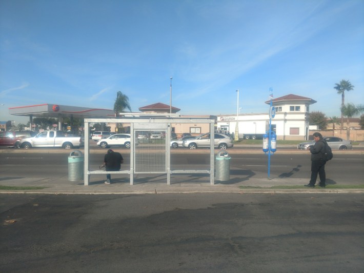 Bus riders wait at eastbound bus stop at Westminster Avenue and North Harbor Boulevard. Kristopher Fortin/Streetsblog CA