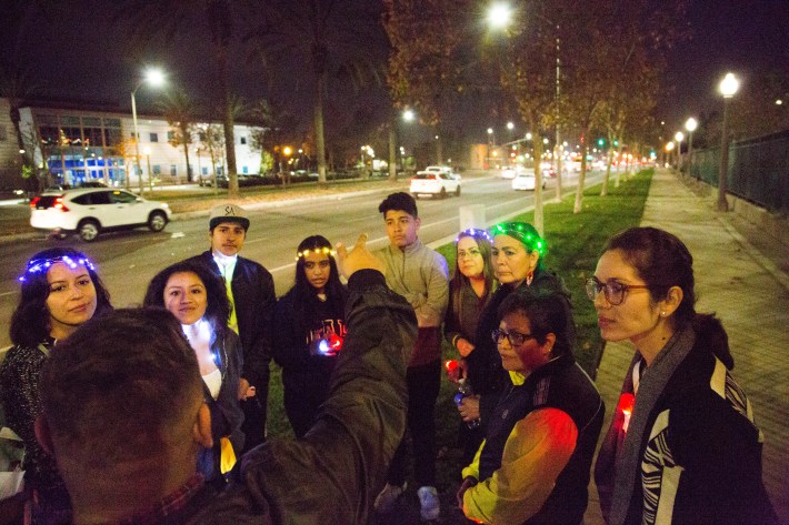 One of the walking groups listen to a speaker during the Dec. 14 Walk of Lights. Image: Santa Ana Active Streets