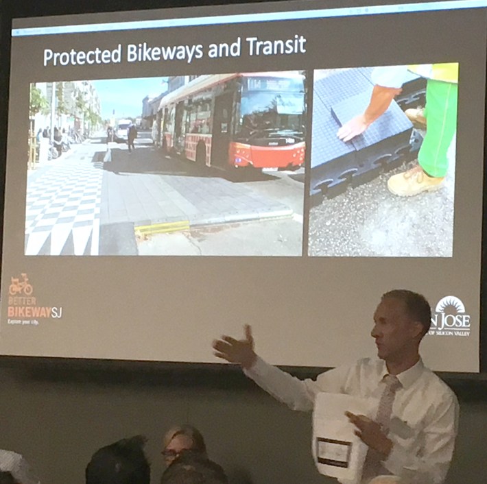 Peter Trinh of the Seattle DOT shows off Seattle's "lego" plastic portable bus platforms.
