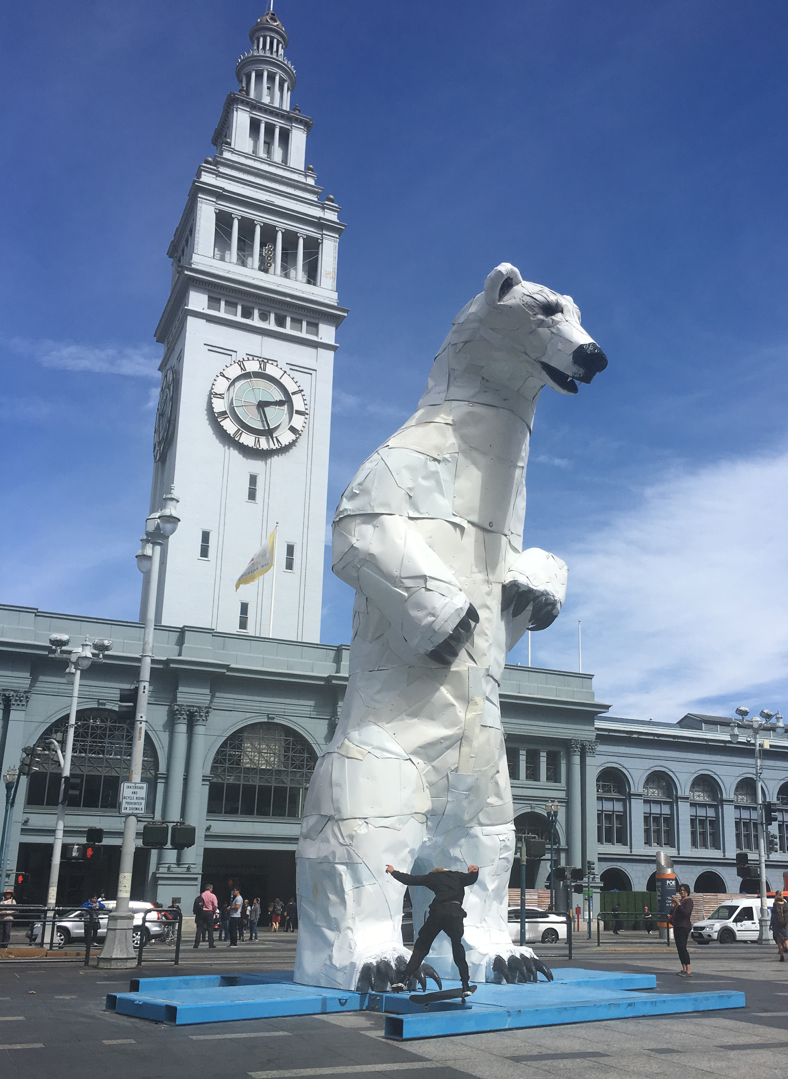 A polar bear made of car parts hosts skateboarder tricks at the San Francisco Ferry Building to mark the Global Climate Action Summit