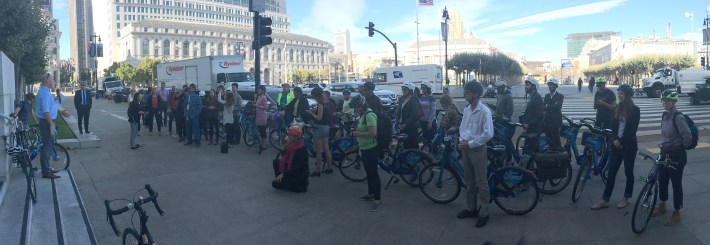 The San Francisco Bicycle Coalition hosted a bike ride as part of the summit. Here the group stops at City Hall to discuss the city's achievements and work still to be done.