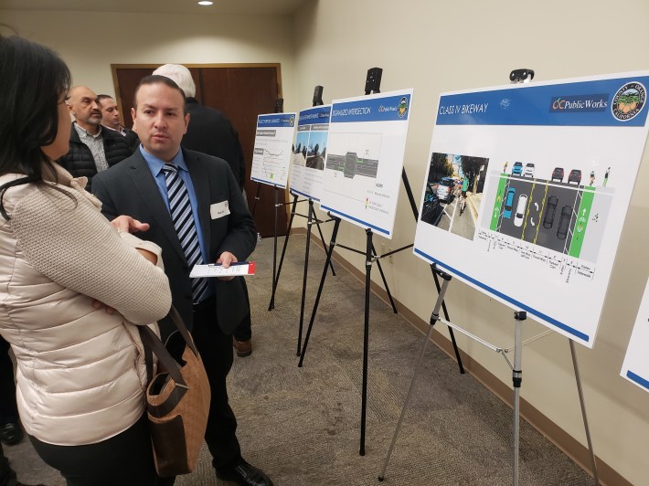 Adolfo Ozaeta, traffic engineer for City of Westminster, talks to a community member during the County's community meeting about the Hazard Avenue Improvement Project. Kristopher Fortin/Streetsblog CA