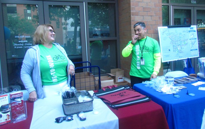 Local transit agencies pass out information and free stuff, and enjoy the chocolate chip cookies provided by the Doubletree Hotel.