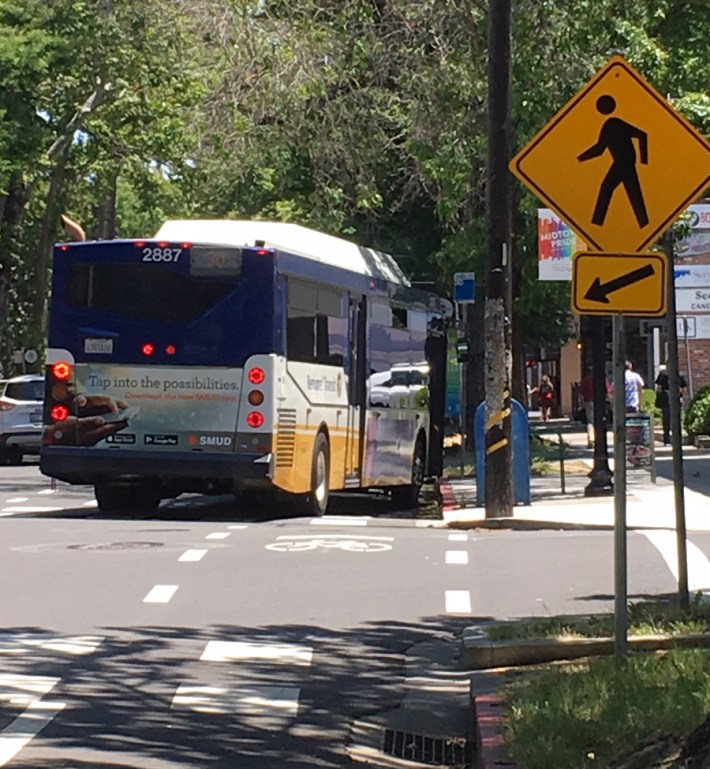 What to do about bus stops is still in discussion. They are marked to the left of the bike lane. The rider that exited the bus here used two crutches, and the driver had the bus kneel down to let him out.