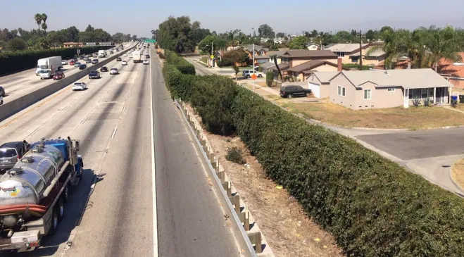 View of Downey freeway from overpass, with houses off to the side