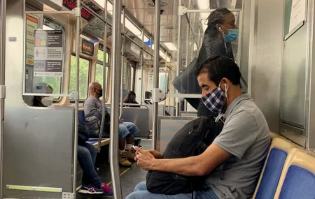 Transit riders wearing masks