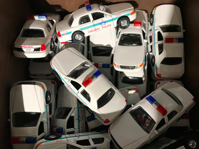 Pile of toy cop cars, ala Blues Brothers