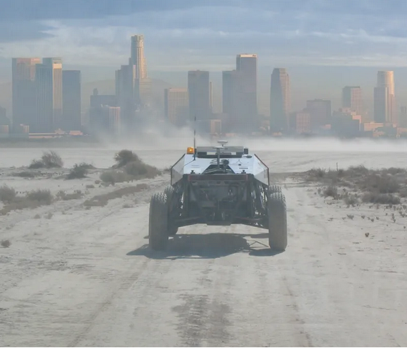 futuristic vehicle in the dust heading towards a city