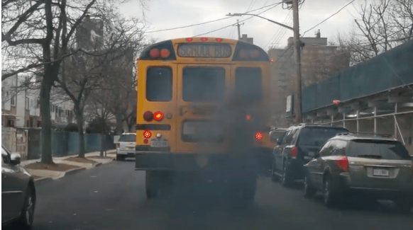 School bus blowing black smoke