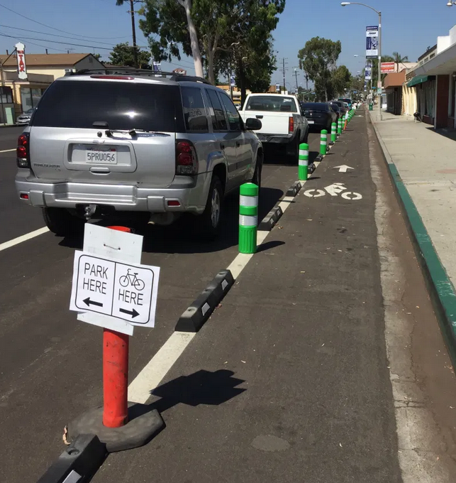 cars parked to left of a bike lane, curb on right