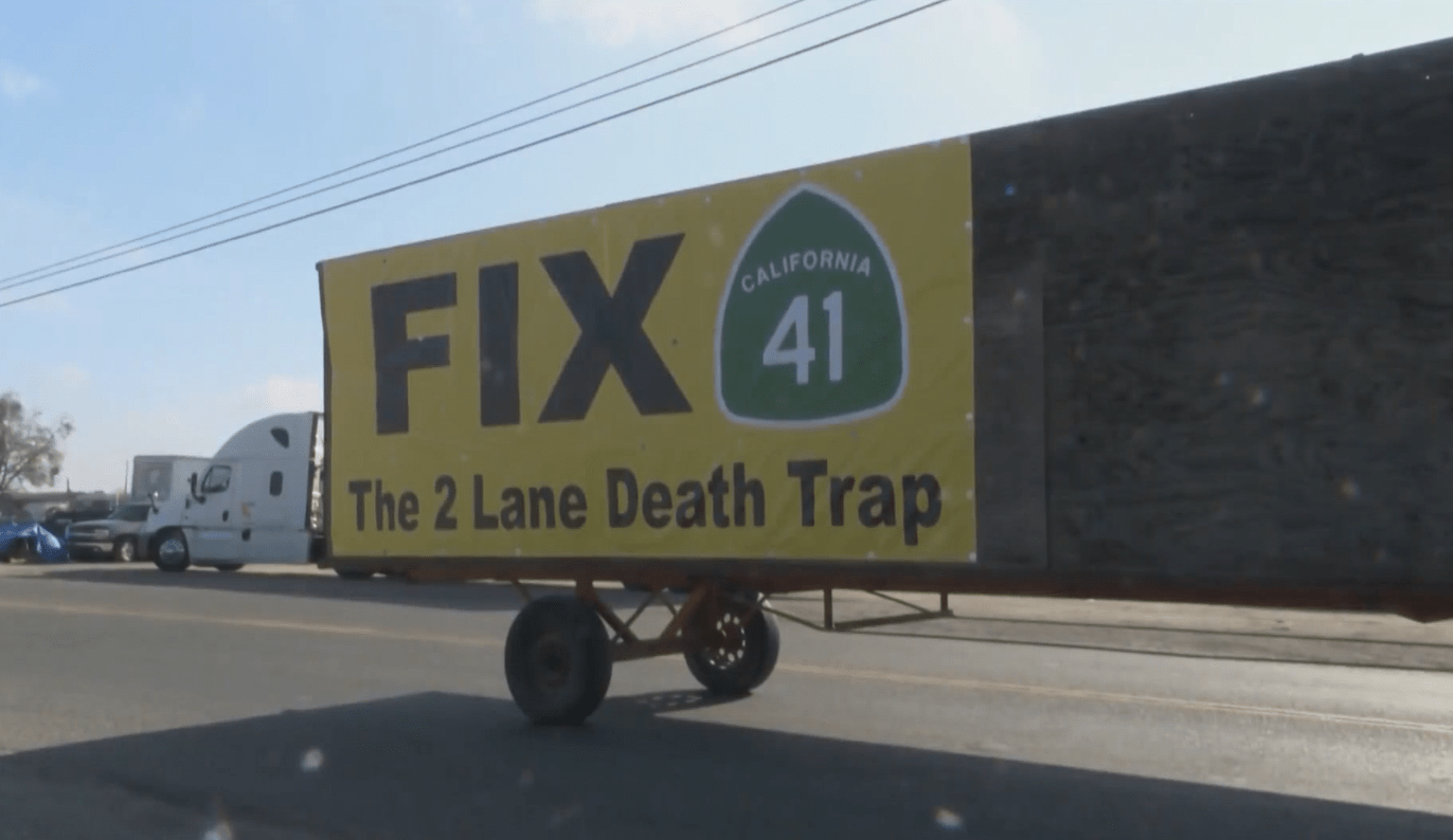 Billboard on a truck reads "Fix the 2-lane death trap" of Highway 41