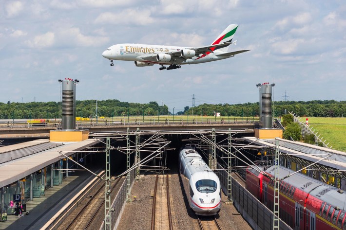 F04EXF Airbus A380 approaching runway Duesseldorf airport train station rail transport ICE international express train Germany Europe