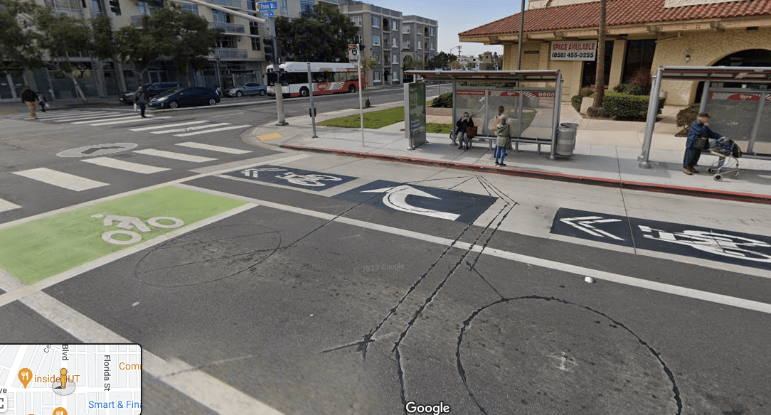 Park Blvd, San Diego, where bike riders merge with buses pulling up to a bus stop and right-turning vehicles. Image: Google Streetview
